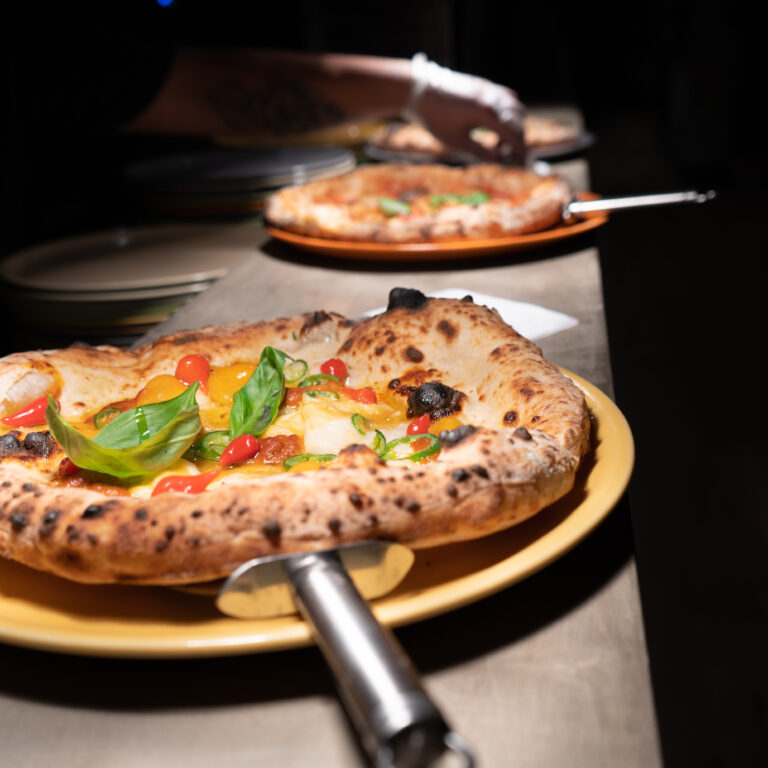 Fresh pizzas on the pass Fresh pizzas on the pass