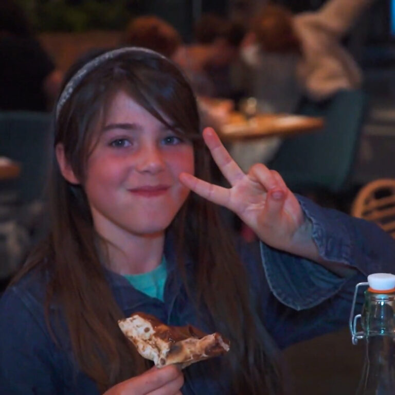 Girl eating chocolate pizza at Purezza Bristol